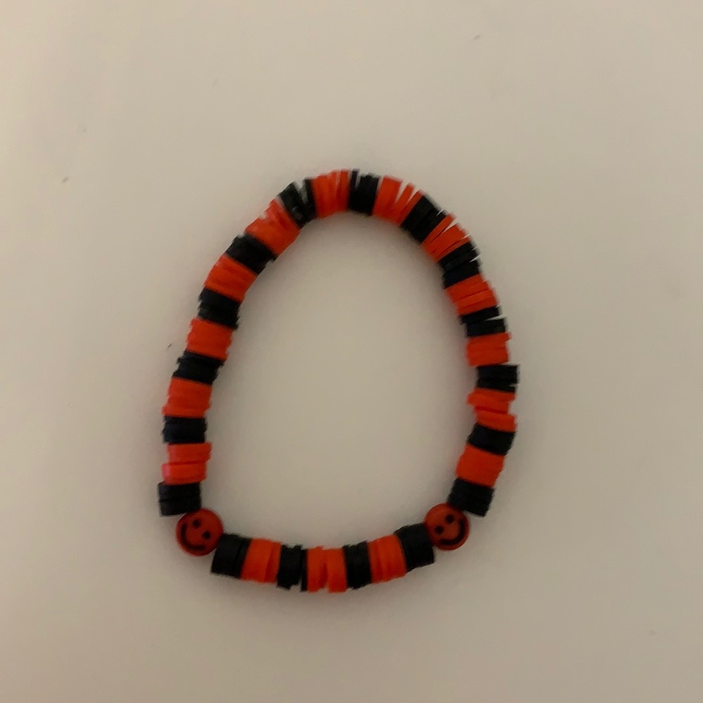 Red and black smiley face bracelet.